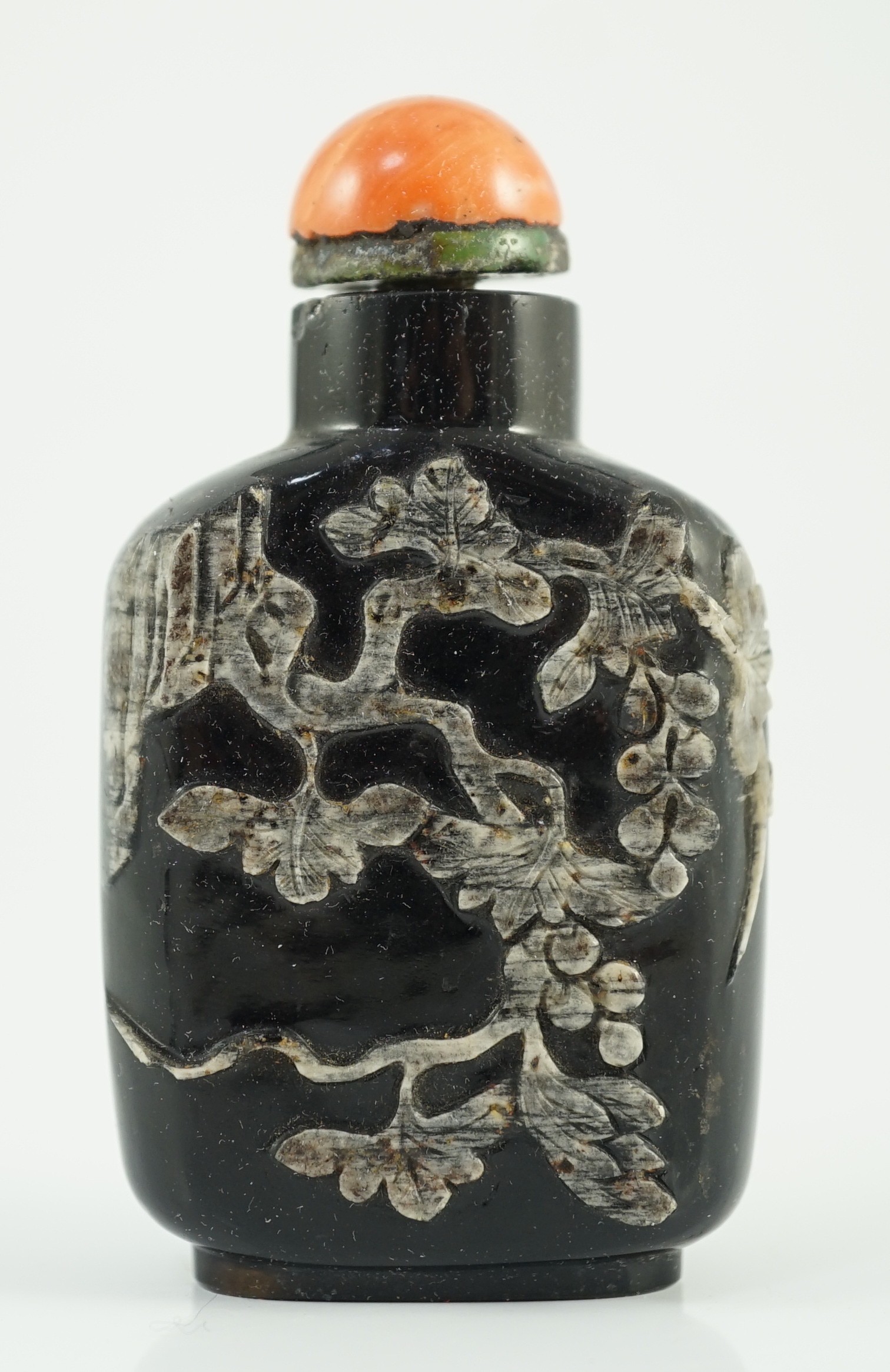 A Chinese smoky quartz snuff bottle, 1780-1820, 6.7cm high, coral stopper